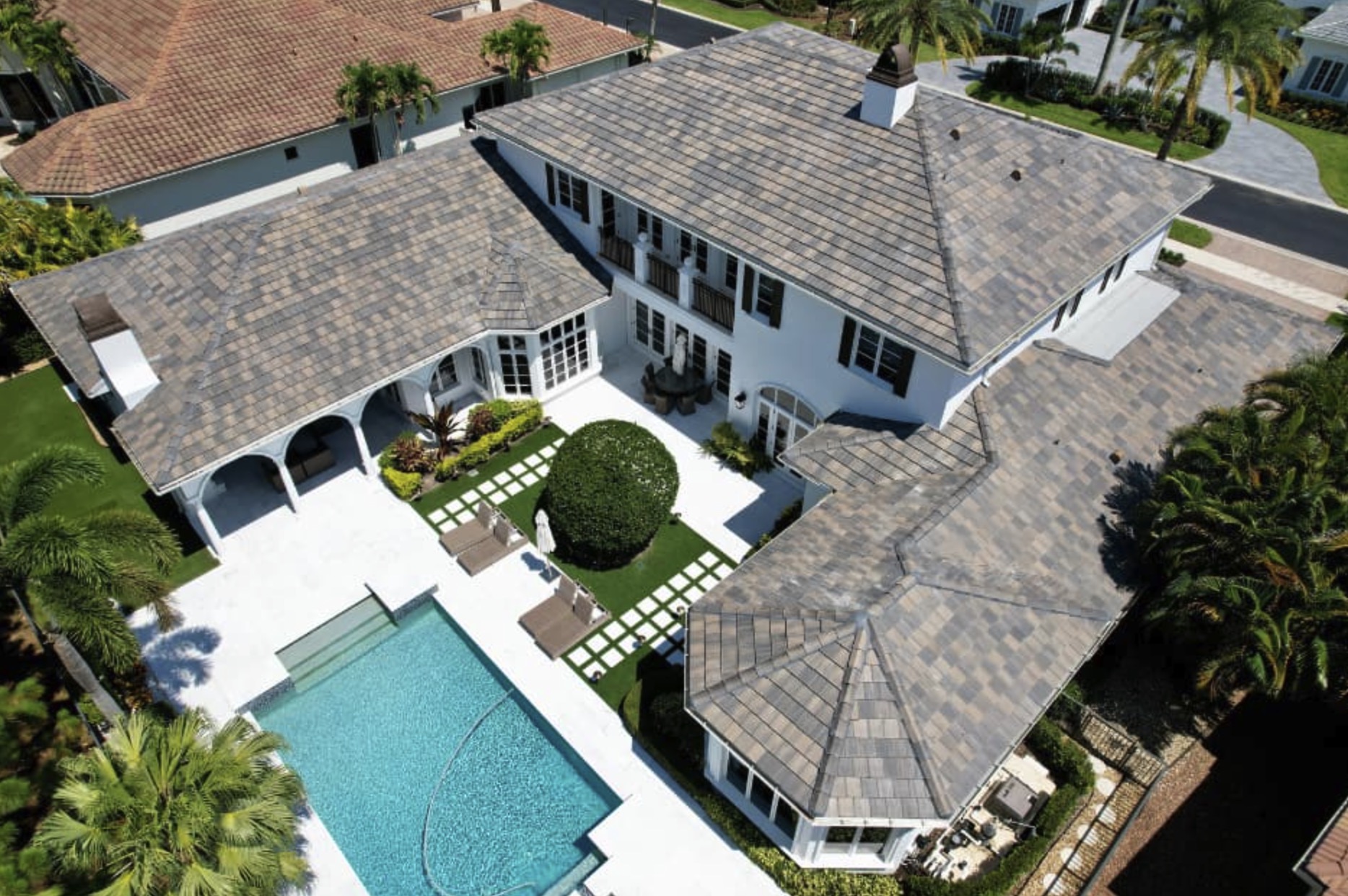 Aerial drone view of a luxury residential property showing a full tile roof replacement completed by Supreme Restorations in Palm Beach County, Florida