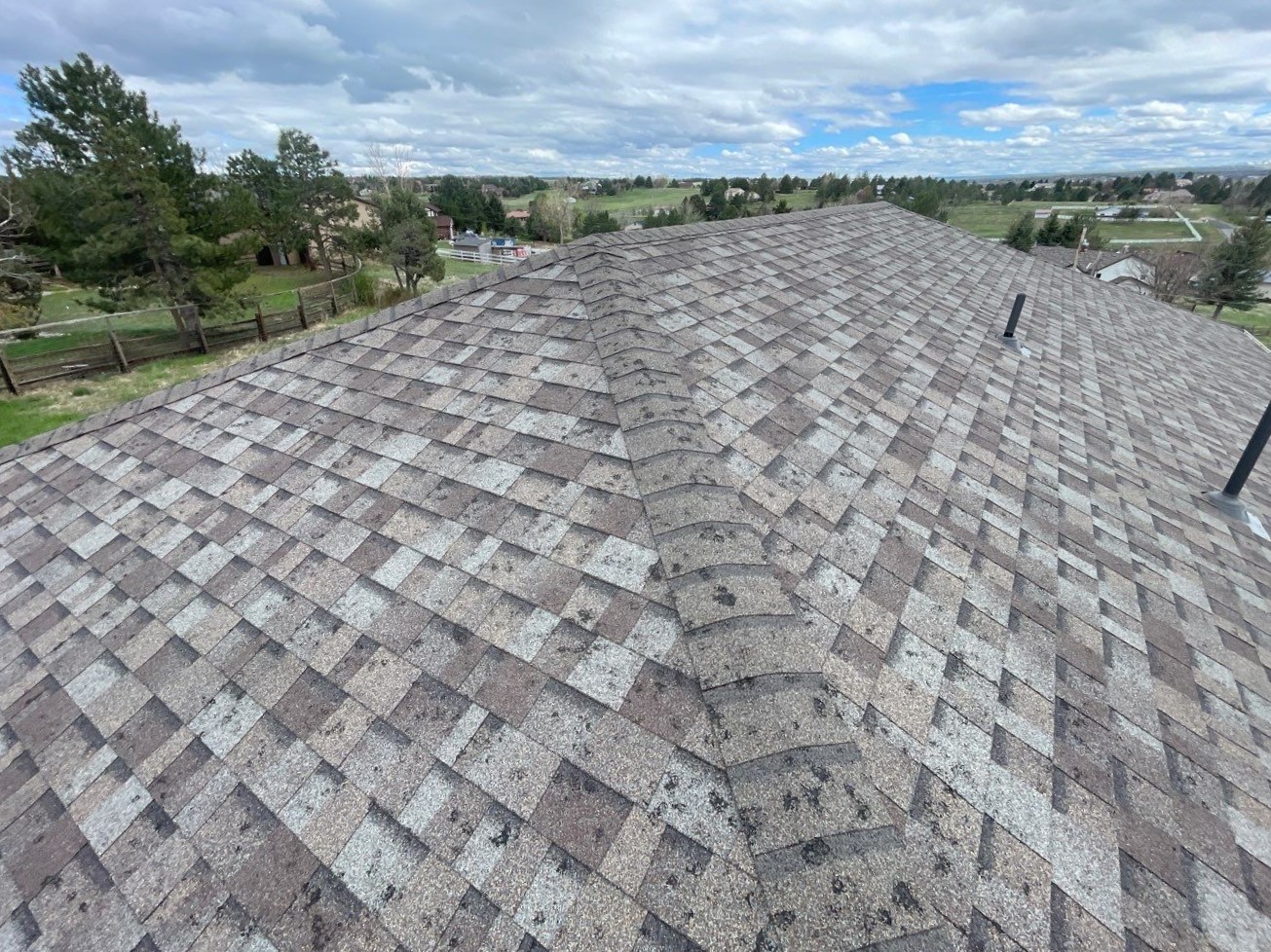 Hail-damaged asphalt shingles documented for an insurance claim on a Maryland home